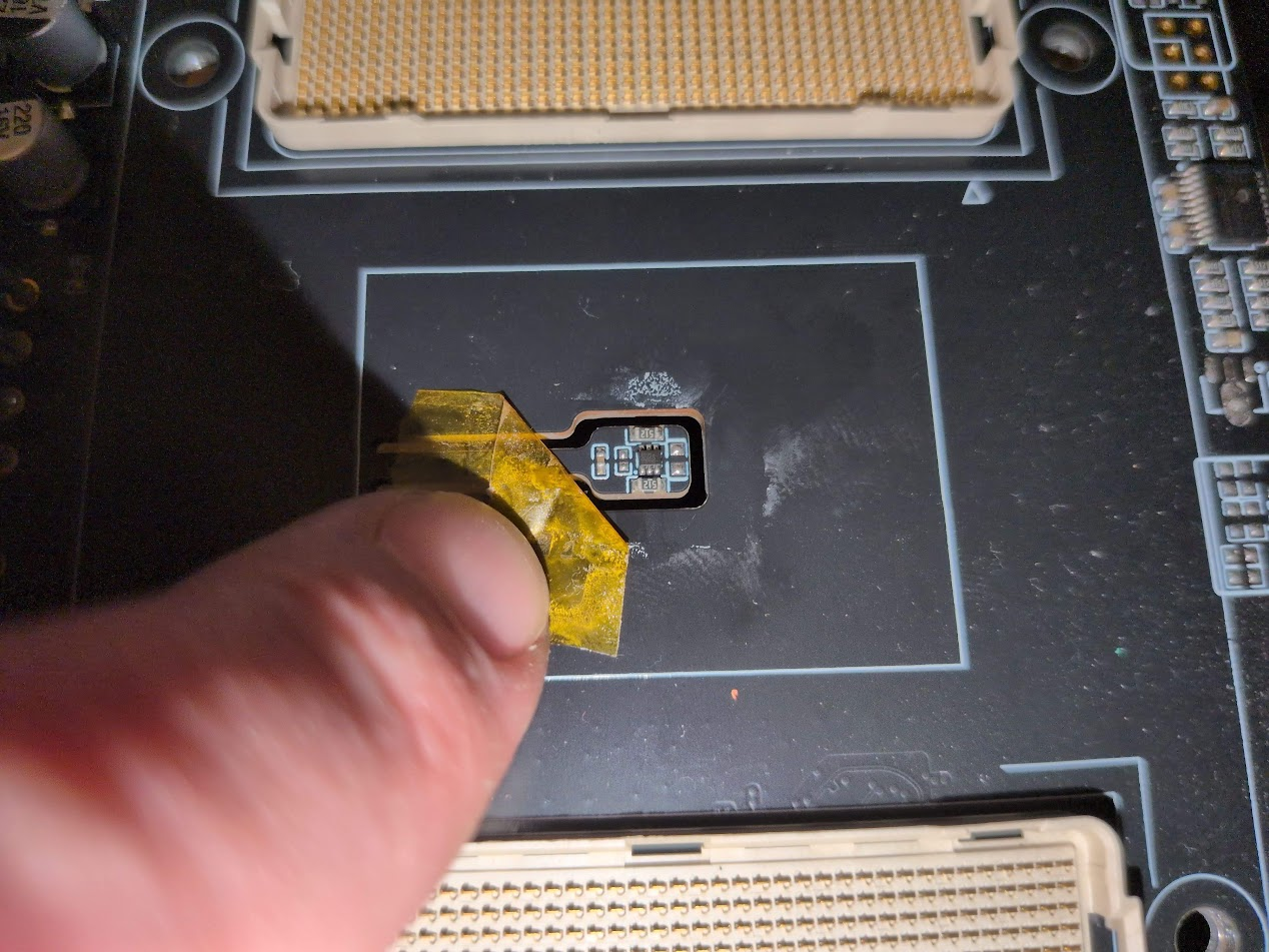 A temperature-sensor flex board lifted from under the V100 SXM2 socket